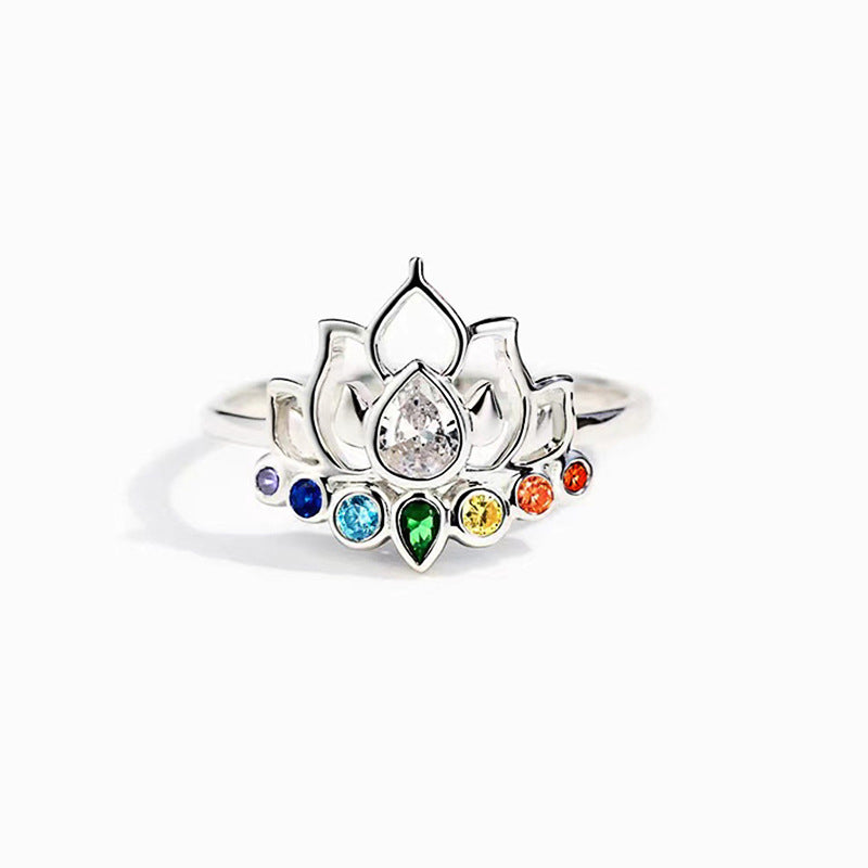 Silver tone copper ring with a lotus flower design and multicolor zircon stones on a soft background