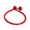 Close up of a red woven string bracelet with two ceramic beads