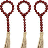 Three sets of wooden bead curtain tiebacks with tassels in various colors