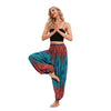 Model wearing colorful boho harem pants in a yoga pose