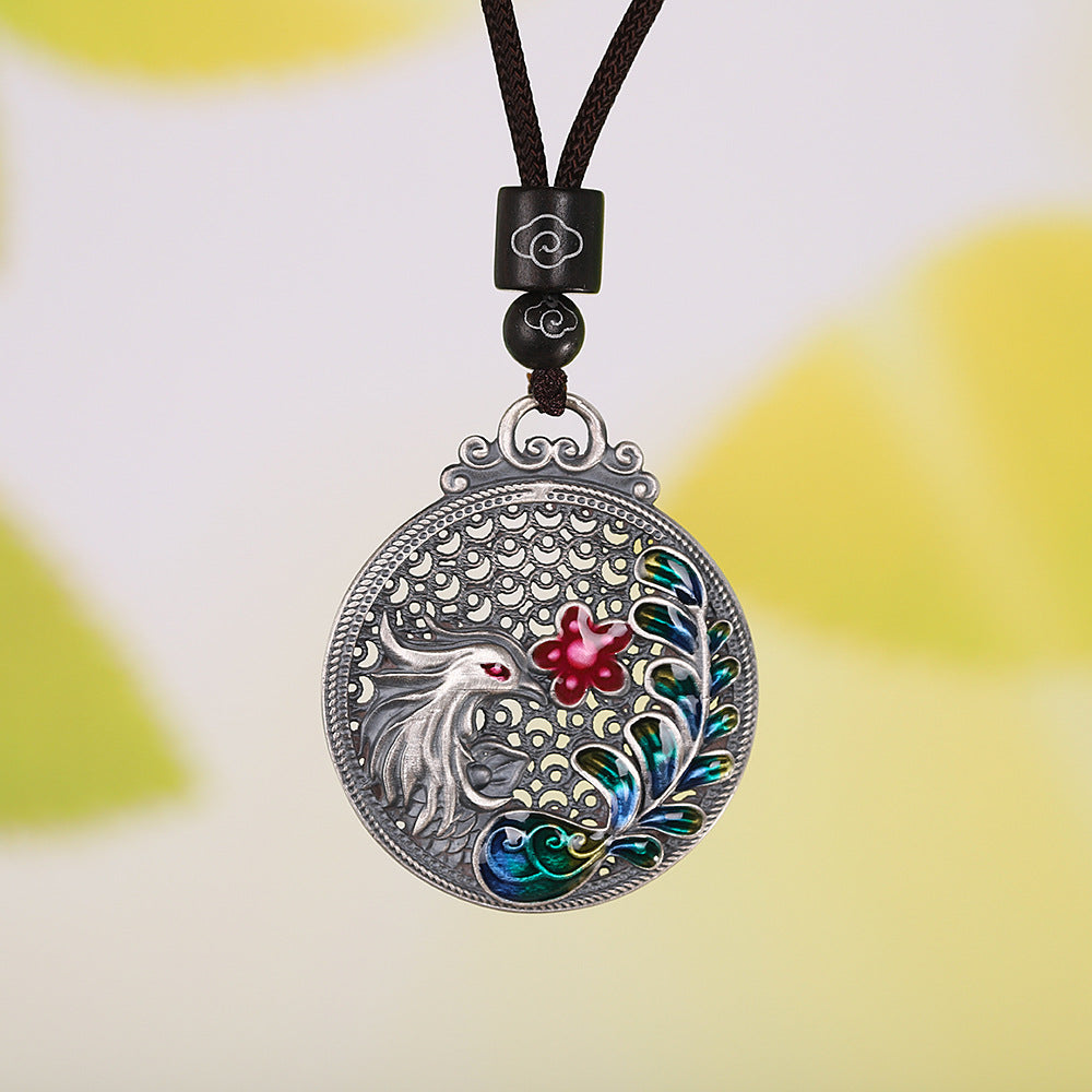 Round 990 silver pendant with a phoenix and flower design on a black cord