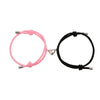 Pair of pink and black magnetic heart couple bracelets connected by the clasp