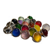 A pile of multicolored round resin buttons with rose gold tone backs on a white background