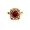 Gold tone ring with a large red lab-created ruby and geometric halo setting