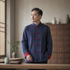 Man wearing a blue cotton linen tang suit jacket with red cuffs