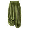 Four pairs of women's cotton slub pants in green, white, grey, and pink laid flat on a beige surface.