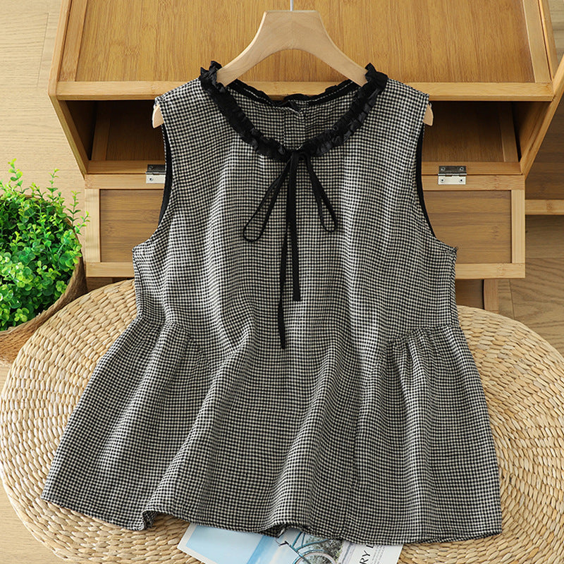 Front view of a black and white plaid sleeveless top with lace trim and tie neck on a hanger