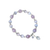 Purple amethyst and cat's eye bead bracelet with a silver star charm on a wrist