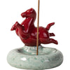 Red ceramic horse figurine standing on a green crackle-glaze base holding an incense stick