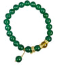Green agate beaded bracelet with gold snake charm on wooden stand