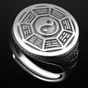 Close up of a silver tone adjustable ring with a round face showing the Bagua trigrams and Yin Yang symbol