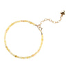 Close up view of a yellow citrine beaded bracelet with a gold heart charm on a white background