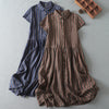 Two striped linen dresses laid flat, one blue and one brown