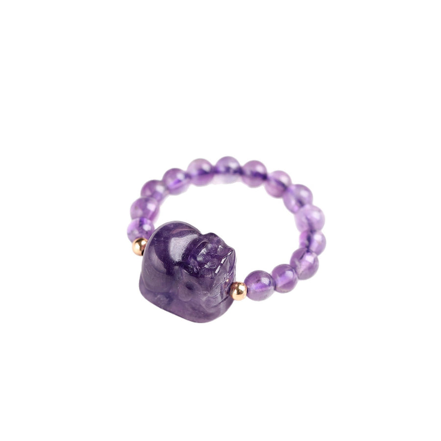 Close up of a purple amethyst beaded ring with a carved Pixiu charm