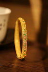 Gold-Tone Filigree Bangle with Green Stones