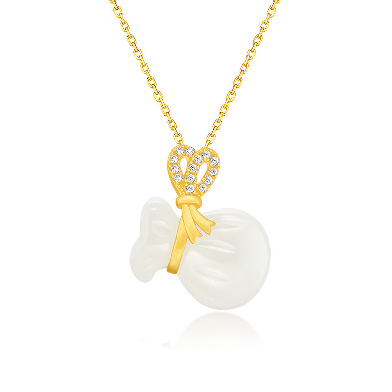 Close up of a white jade money bag pendant on a gold chain