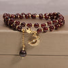 Double wrap beaded bracelet with moon charm on a wooden surface