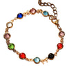 Gold-tone chain bracelet with multi-colored round glass stones and a small butterfly charm