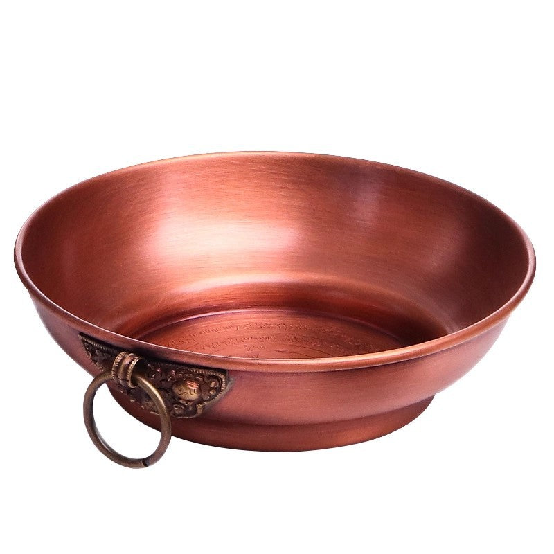 Polished copper ritual bowl with engraved patterns inside and ring handles