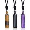 Three crystal cylinder pendants on black cords featuring tiger eye, black agate, and amethyst