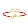 Gold-tone horse charm on a braided red string bracelet