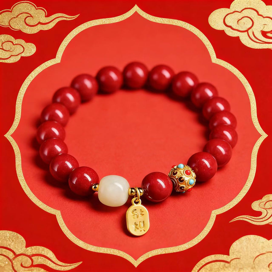 Red cinnabar bead bracelet with gold-tone charm on a red background