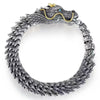 Vintage copper dragon bracelet with hook clasp on dark background