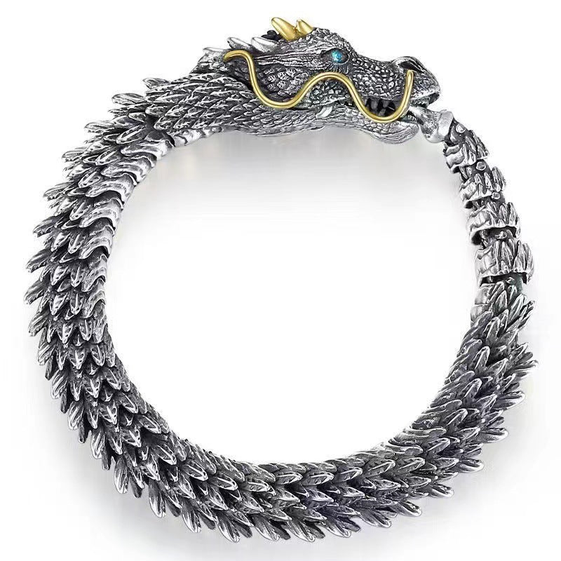Vintage copper dragon bracelet with hook clasp on dark background