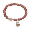 Pink faceted bead bracelet with a gold-tone gourd pendant charm