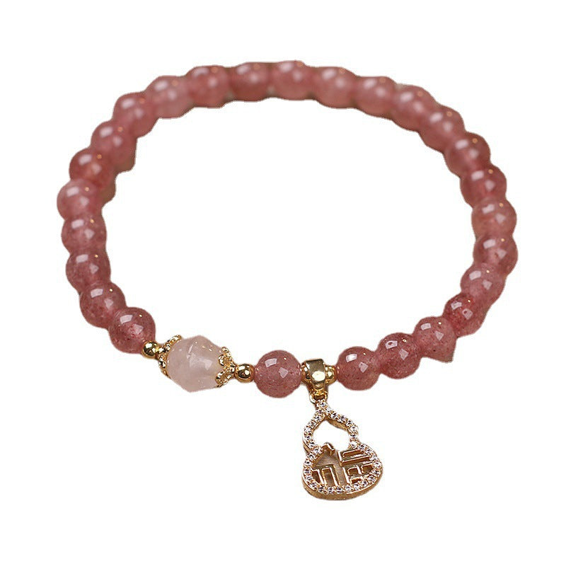 Pink faceted bead bracelet with a gold-tone gourd pendant charm