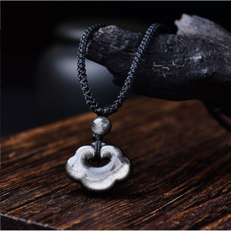 Polished black obsidian pendant in the shape of a cloud on a black cord