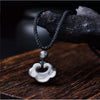Polished black obsidian pendant in the shape of a cloud on a black cord
