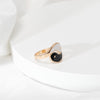 Gold-tone open ring with black and white Yin Yang enamel design on a finger
