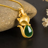 Gold tone copper fox pendant with green chalcedony stone on a box chain
