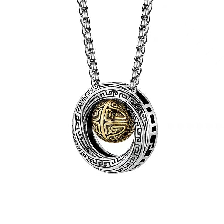 Close up of silver tone Mobius necklace with gold tone center bead