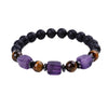 Close-up of a beaded bracelet with black lava rock, tiger eye, and purple amethyst cubes