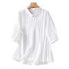 White women's cotton linen shirt with embroidery on a hanger