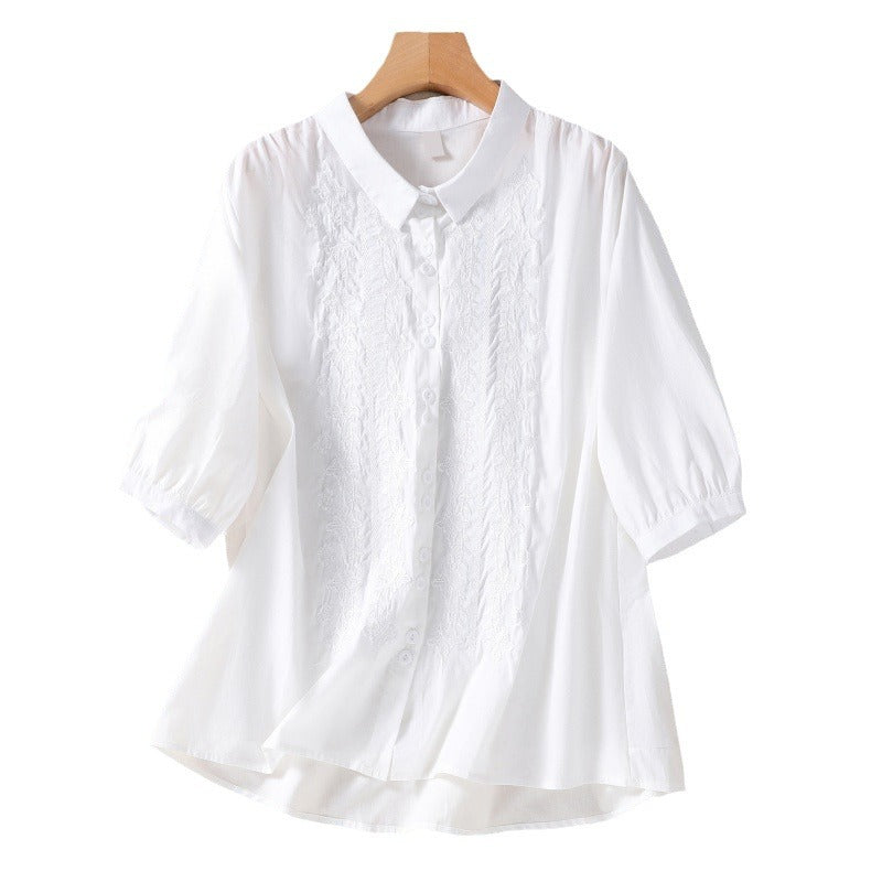 White women's cotton linen shirt with embroidery on a hanger