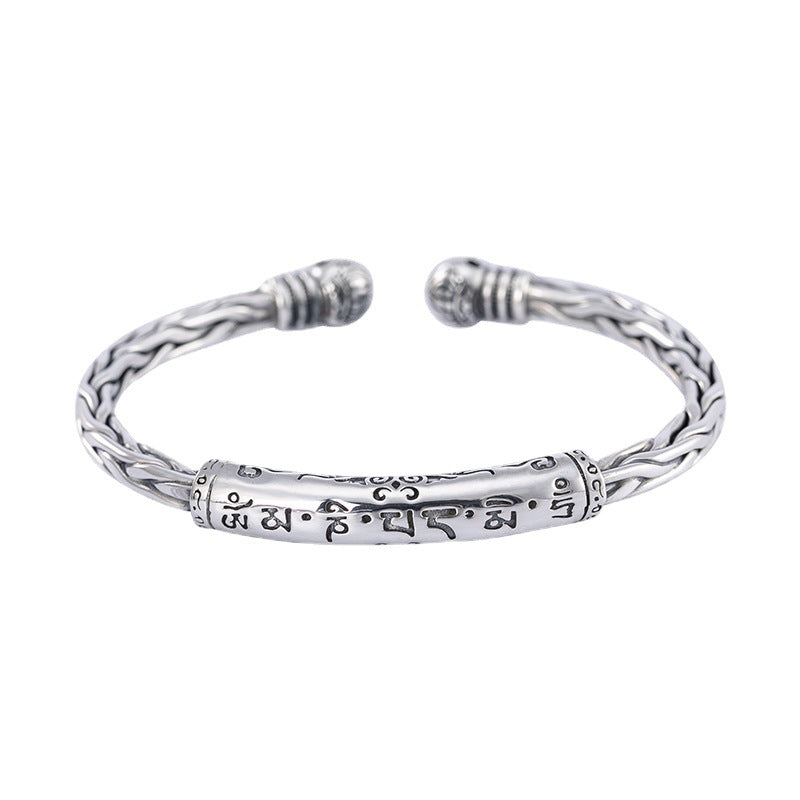 Silver tone rope cuff bracelet with Tibetan script engraving on wrist