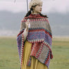 Woman wearing a colorful knitted Tibetan shawl outdoors