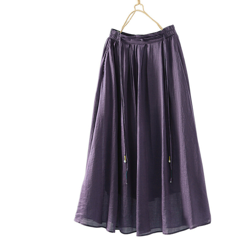Purple solid color tassel design women's skirt hanging on a wooden hanger