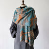 Blue and orange patterned shawl draped over a mannequin