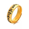 Close up of gold tone adjustable ring with Tibetan script engraving