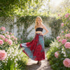 Woman wearing a red and blue printed wrap maxi skirt in a garden