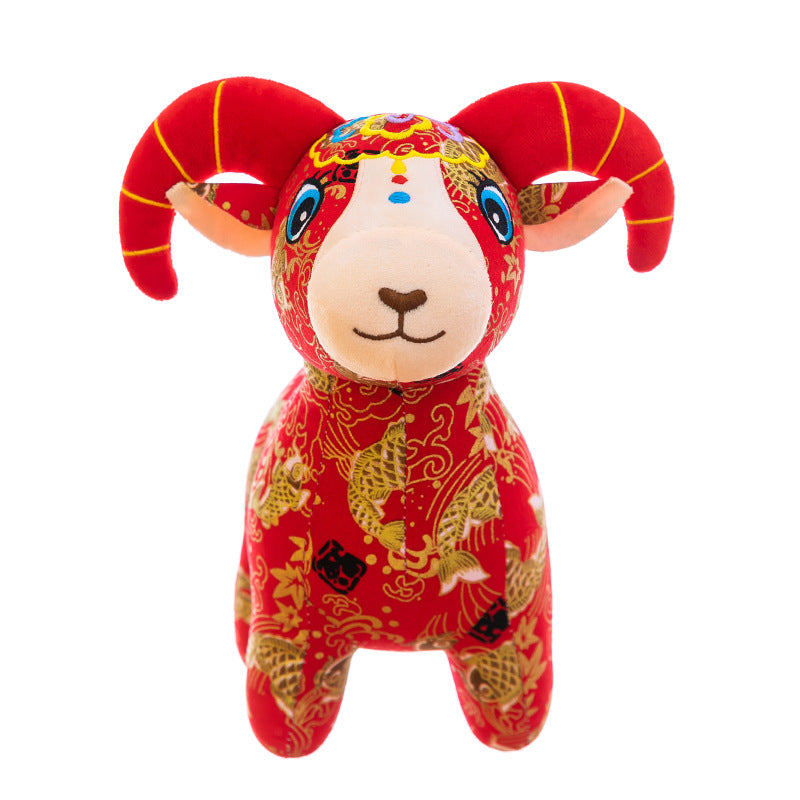 A group of red patterned plush goat toys sitting on a table