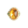 Close-up of a vintage ring with an oval of flower amber in a gold-plated setting