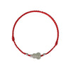 Close up of a red braided bracelet with a white jade gourd charm