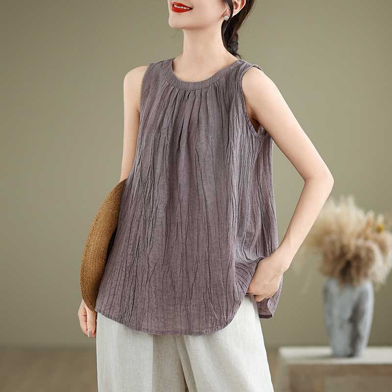 Woman wearing a textured sleeveless cotton linen vest with a round neck