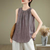 Woman wearing a textured sleeveless cotton linen vest with a round neck