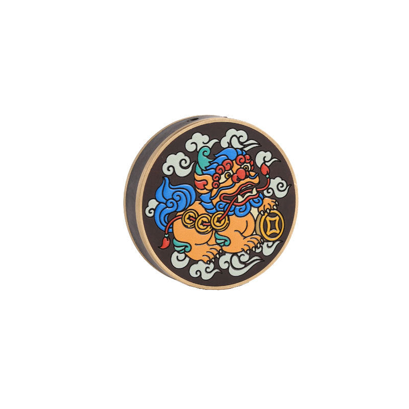 Round wooden keychain charm with a colorful painted Pixiu and copper coin design on a dark background